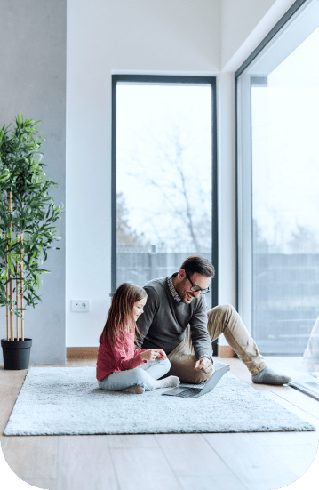 Father and daughter are seated on the floor of their home in a peaceful scene, illustrating the importance of having home insurance in Alberta