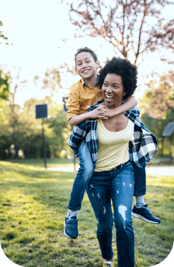 The mother carries her son on her back, and they express joy over possessing the best home insurance in Edmonton